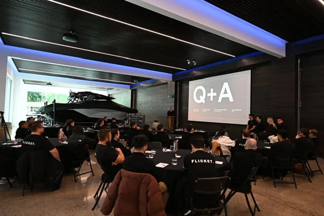 A company offsite in progress at Takapoto Estate, cabaret seating and a presentation on screen